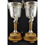 A pair of silver plated and glass table lamps, fleur de lis plated mounts, moulded glass shades,