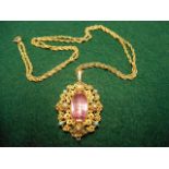 A yellow metal (tests as 15ct gold) filigree pendant set with central pink topaz, bordered by four