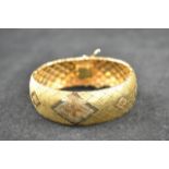 An 18ct gold articulated bracelet with geometric 'diamond' design - approx weight 56.1g.(amended