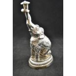 An Indian white metal rosewater sprinkler in the form of a kneeling elephant, late 19th/20th Century