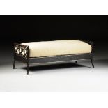 A McGUIRE BLACK PAINTED BAMBOO AND CARVED WOOD "RING" BENCH, LABELED, MODERN, of elongated