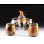 A GROUP OF FIVE ROYAL DOULTON POLYCHROME GLAZED SPRING LIDDED EARTHENWARE HUMIDORS AND ONE