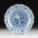 A LARGE DELFT BLUE AND WHITE CHINOISERIE CHARGER, SIGNED, HOLLAND, CIRCA 1750, the round earthenware