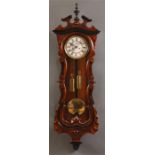 A good late 19th Century Walnut and ebonized Vienna style WALL CLOCK the shaped long door and