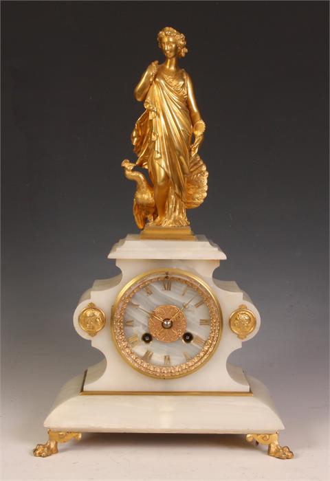 A stylish late 19th Century French Onyx and Gilt Bronze MANTEL CLOCK the shaped case with skirted