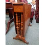 Good Quality Oak Drop leaf Sutherland table with turned supports over brass paw caster feet