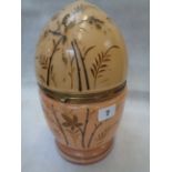 A 19th century Continental reverse painted glass egg shaped decanter box, decorated with Foliage