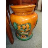 Chinese glazed pottery garden seat of baluster form with pierced tree decoration over green base,