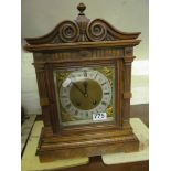 A walnut and mahogany mantel clock with striking movement.