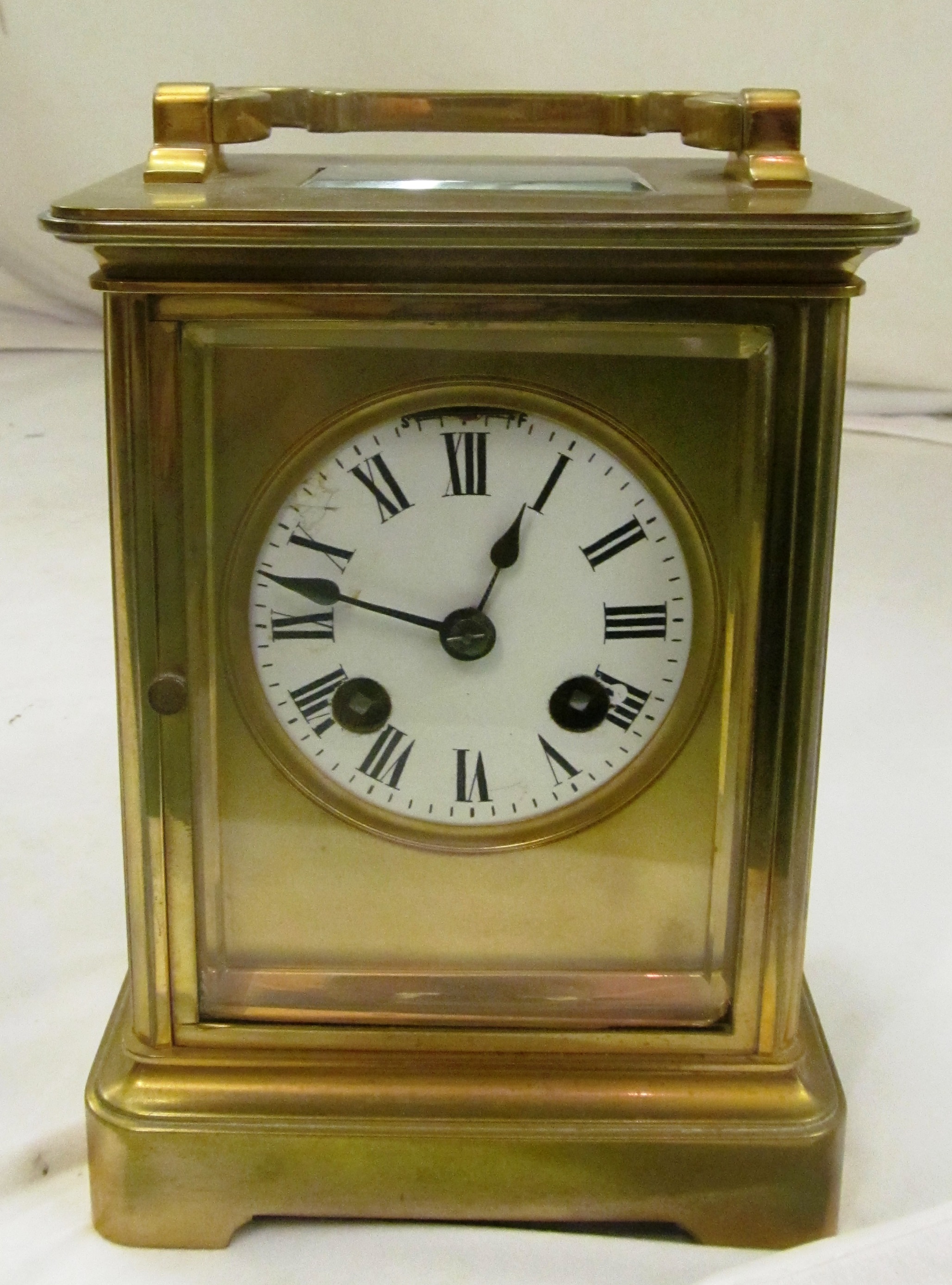 A large 19th Century brass carriage clock, enamel face and eight day striking movement.