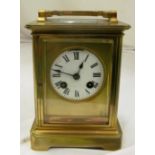 A large 19th Century brass carriage clock, enamel face and eight day striking movement.