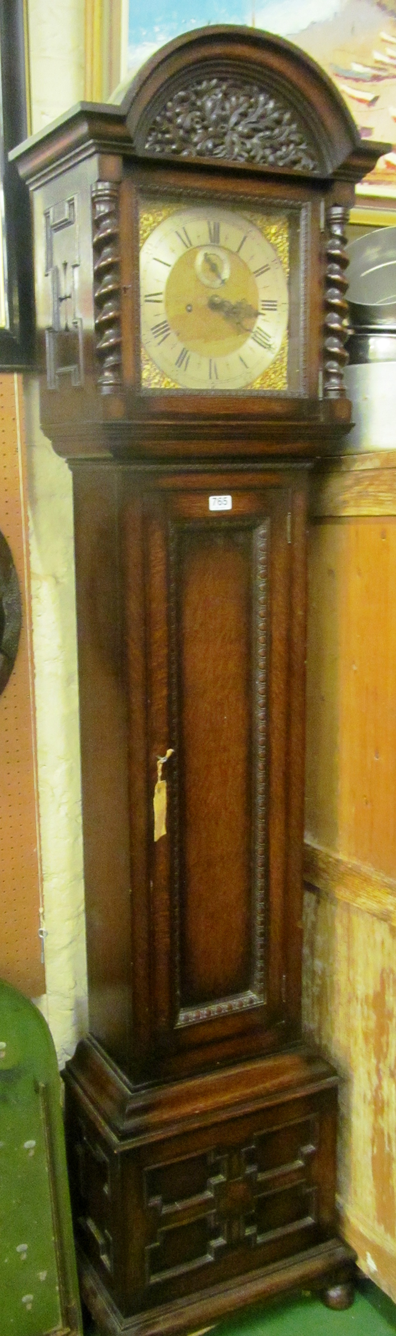 An oak longcase clock with barleytwist pilasters, fielded panelled pendulum door and fielded