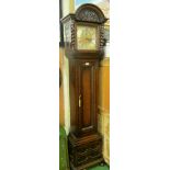 An oak longcase clock with barleytwist pilasters, fielded panelled pendulum door and fielded