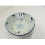 An 18th Century oriental blue and white circular bowl spiral accent design