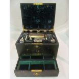 A Victorian (London 1863) black leather vanity box, velvet lined and with fitted interior:- Seven