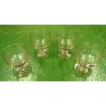 A set of four 19th Century cut glasses with etched border and hollow stem