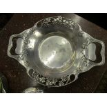 A pewter plate with green glass dish and other pewter items