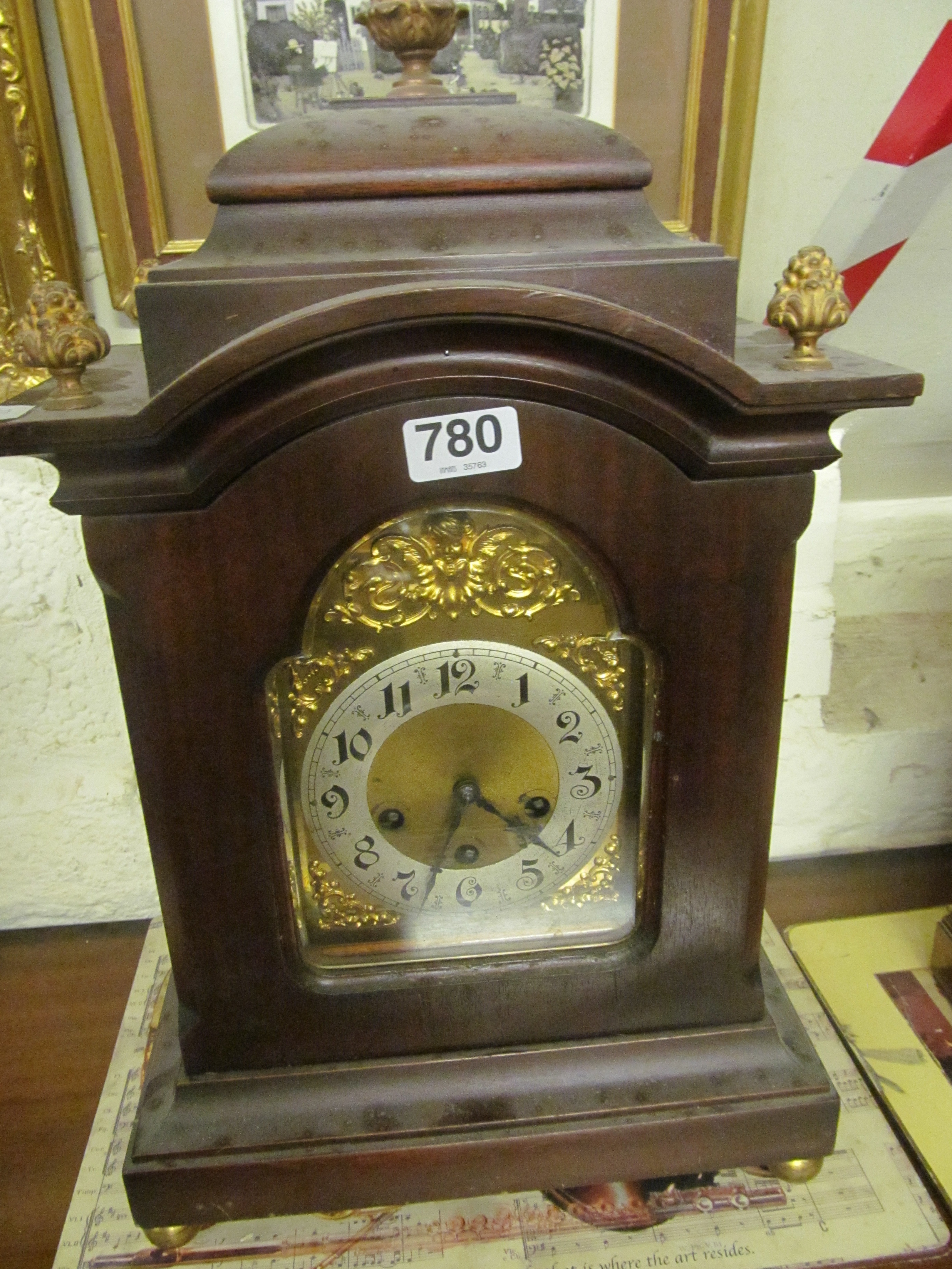 An Edwardian mantel clock 8 day striking movement with gilt finials