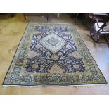 A Qum silk and wool carpet with green, blue and beige Persian design 9'4"x6'1" with original