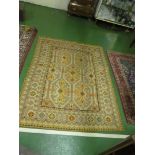 A wool work rug beige ground stylized pattern in muted colours