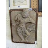 A plaster tile of eastern god