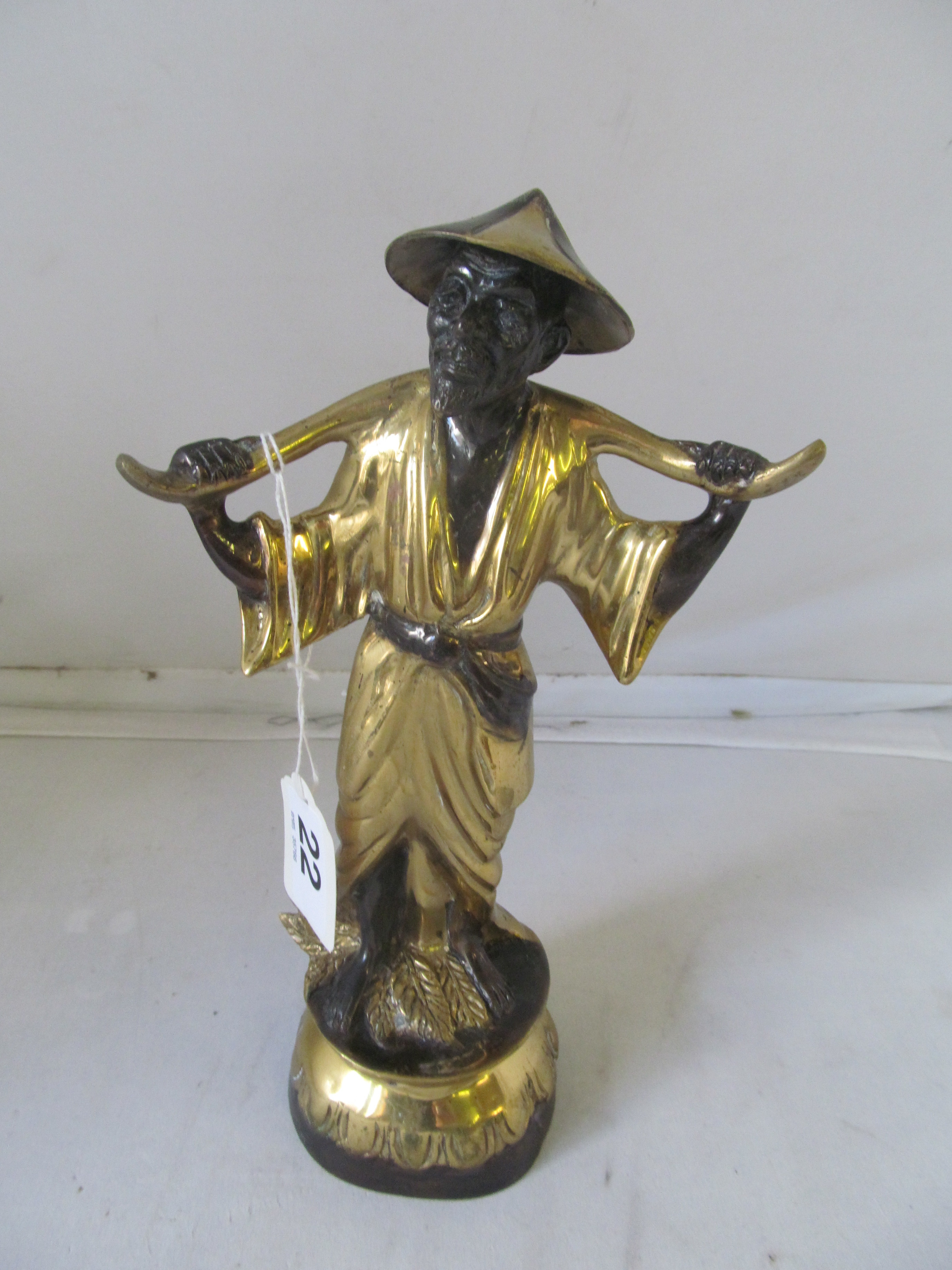 A bronze oriental model of gent with yoke