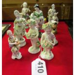 A pair of 18th Century Derby putti and thirteen other small porcelain figures