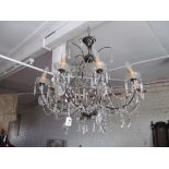 A pair of large modern chandeliers with lustre drops.