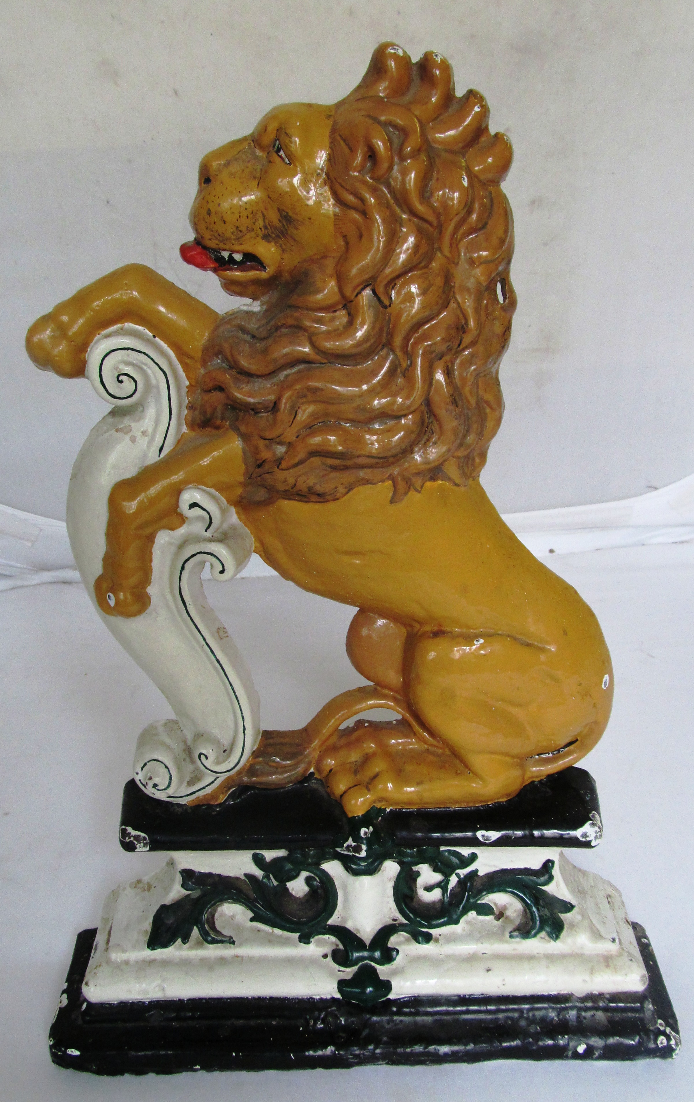 A 19th Century painted door stop in the form of rampant lion.