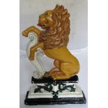 A 19th Century painted door stop in the form of rampant lion.