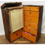 An early 20th Century Louis Vuitton wardrobe trunk with pull out hanging rail and a set of stamped