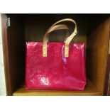 A Louis Vuitton red patent handbag