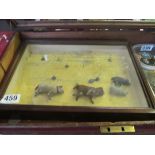 A display case with four toy animals