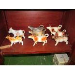 Eight brown standing cow creamers (s/a/f).