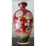 An early 20th century Japanese Satsuma vase decorated flowers on an iron red ground