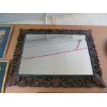 A carved oak mirror