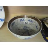 A Chinese bowl with brown greek key border and scene of huntsman in blue