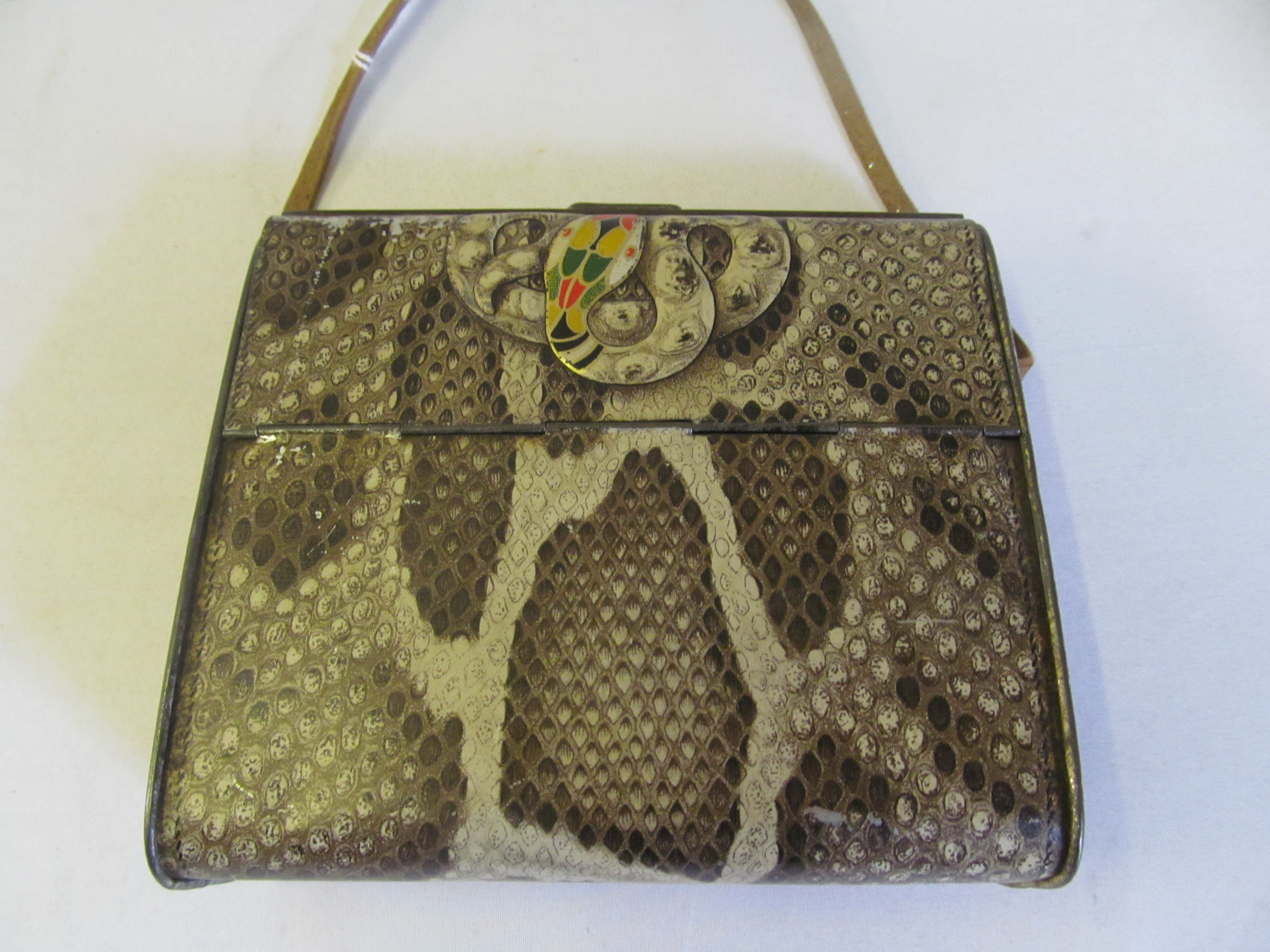 A novelty Huntley & Palmers biscuit tin in the form of a snakeskin handbag