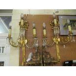 A pair of gilt ormolu bow and tall three branch wall lights with lustre drops.