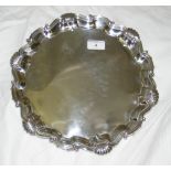 A 32cm diameter late Victorian silver salver with embossed rim and ball and claw feet - London 1898