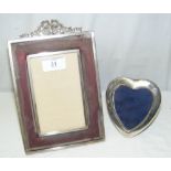 A silver mounted photo frame with cast surmount, together with a small hear-shaped ditto