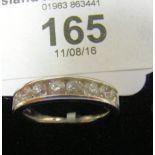 A 9ct white gold half-hoop eternity ring (approximately 1 carat)