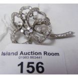 An 18ct white gold set flower brooch mounted with numerous diamonds