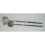 A continental toddy ladle with 1725 coin to the base and a similar George II silver toddy ladle,