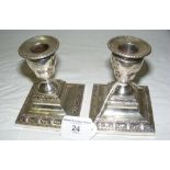 A pair of embossed silver candlesticks by Hawksworth, Eire & Co, Sheffield 1896