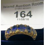 An 18ct yellow gold five stone sapphire and diamond eternity ring