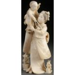 A FINE JAPANESE CARVED IVORY OKIMONO OF A WOMAN AND CHILD, MEIJI PERIOD OR PERHAPS EARLIER.
