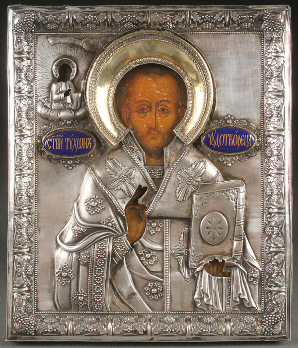 A RUSSIAN ICON OF ST. TIKHON WONDERWORKER, 18TH CENTURY. Overlaid with a very fine and heavy silver