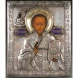 A RUSSIAN ICON OF ST. TIKHON WONDERWORKER, 18TH CENTURY. Overlaid with a very fine and heavy silver