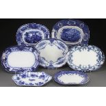 SEVEN STAFFORDSHIRE FLOW BLUE AND TRANSFERWARE PLATTERS, 19TH CENTURY. Comprising a “Nonparial” by